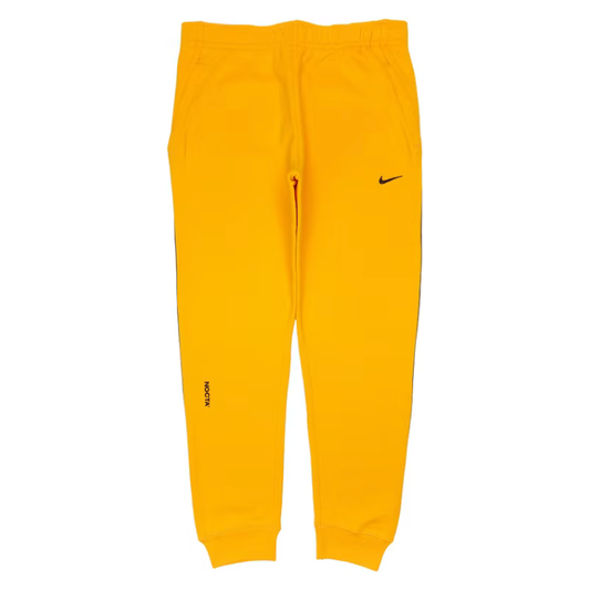 Nike x Drake NOCTA Fleece Pants Yellow by Nike in Uncategorized. Available at KershKicks for £100.00. A must-have for fans of Nike looking to elevate their style with this Sweatpants.